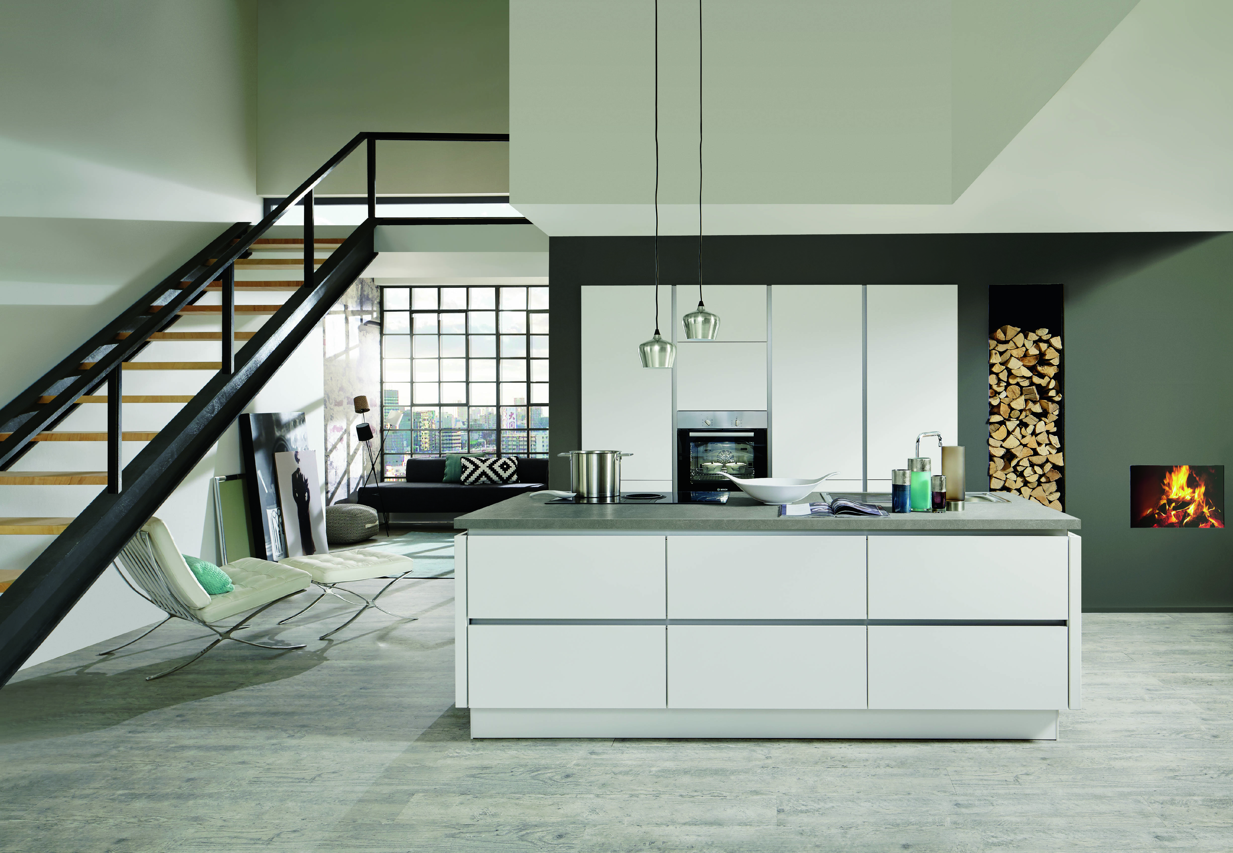 Bright open concept kitchen with white cabinetry, a large island, and a connected living area